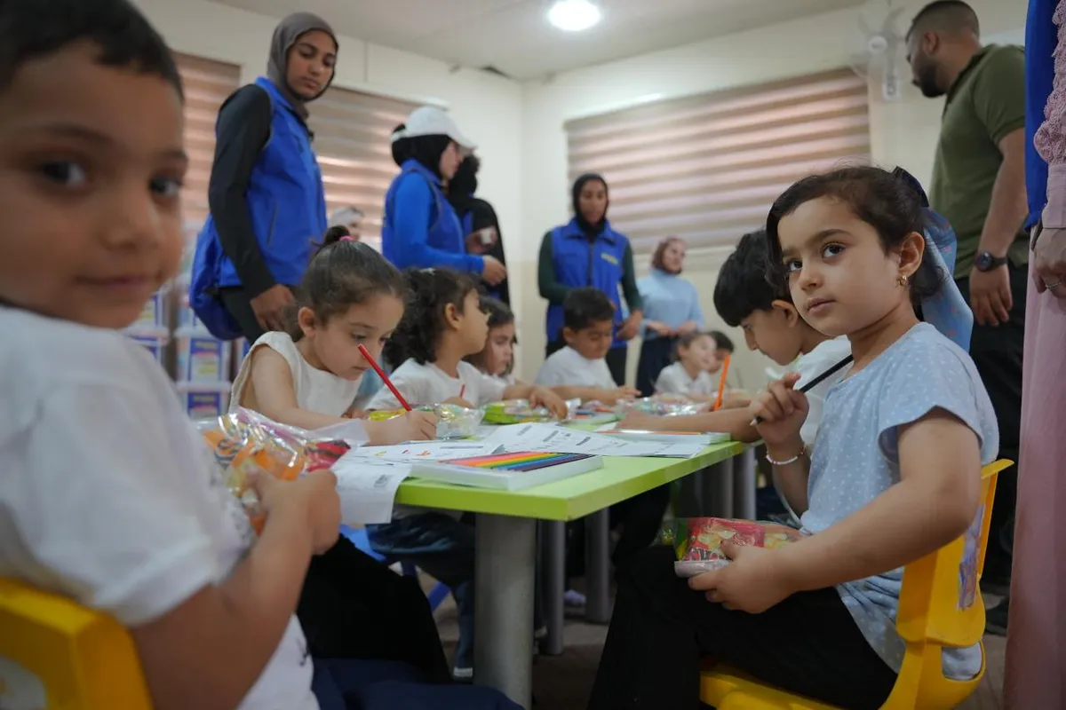 Volunteers with children in a classroom